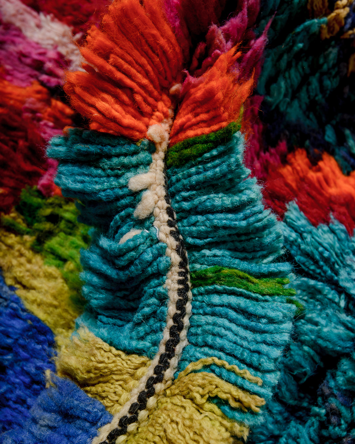 Detail of colourful wool of Berber rug showing the density of knots.